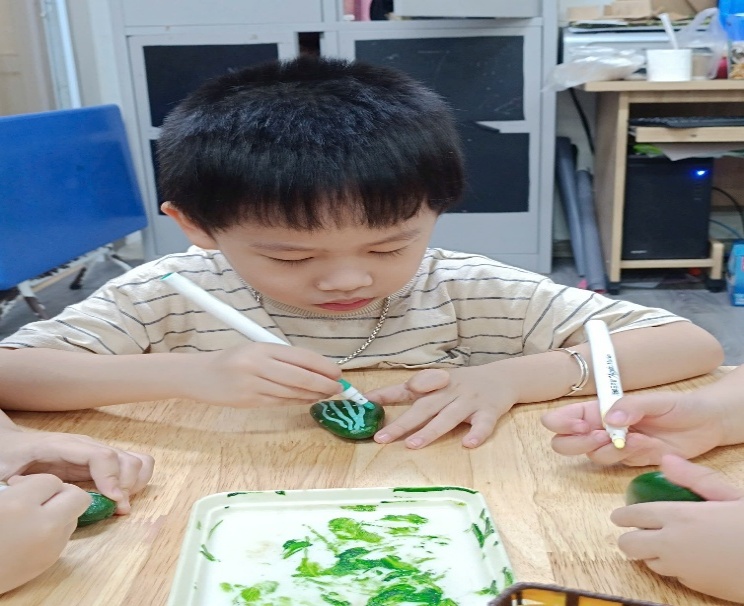 A child painting eggs on a table
AI-generated content may be incorrect.