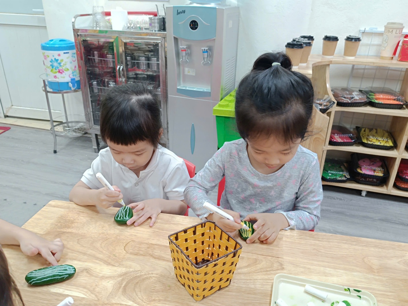 Two children painting on a table
AI-generated content may be incorrect.