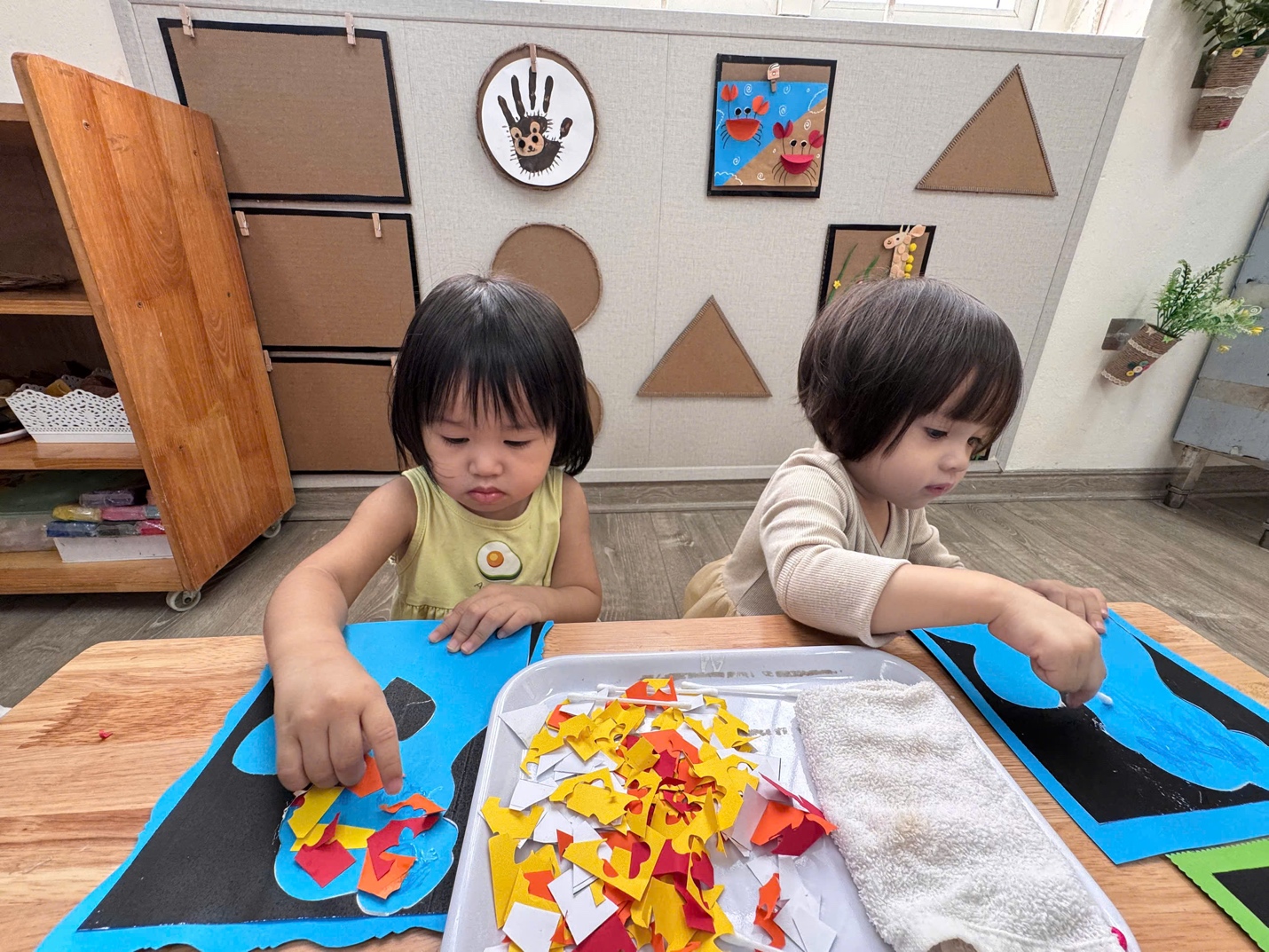 Two children playing with paperAI-generated content may be incorrect.