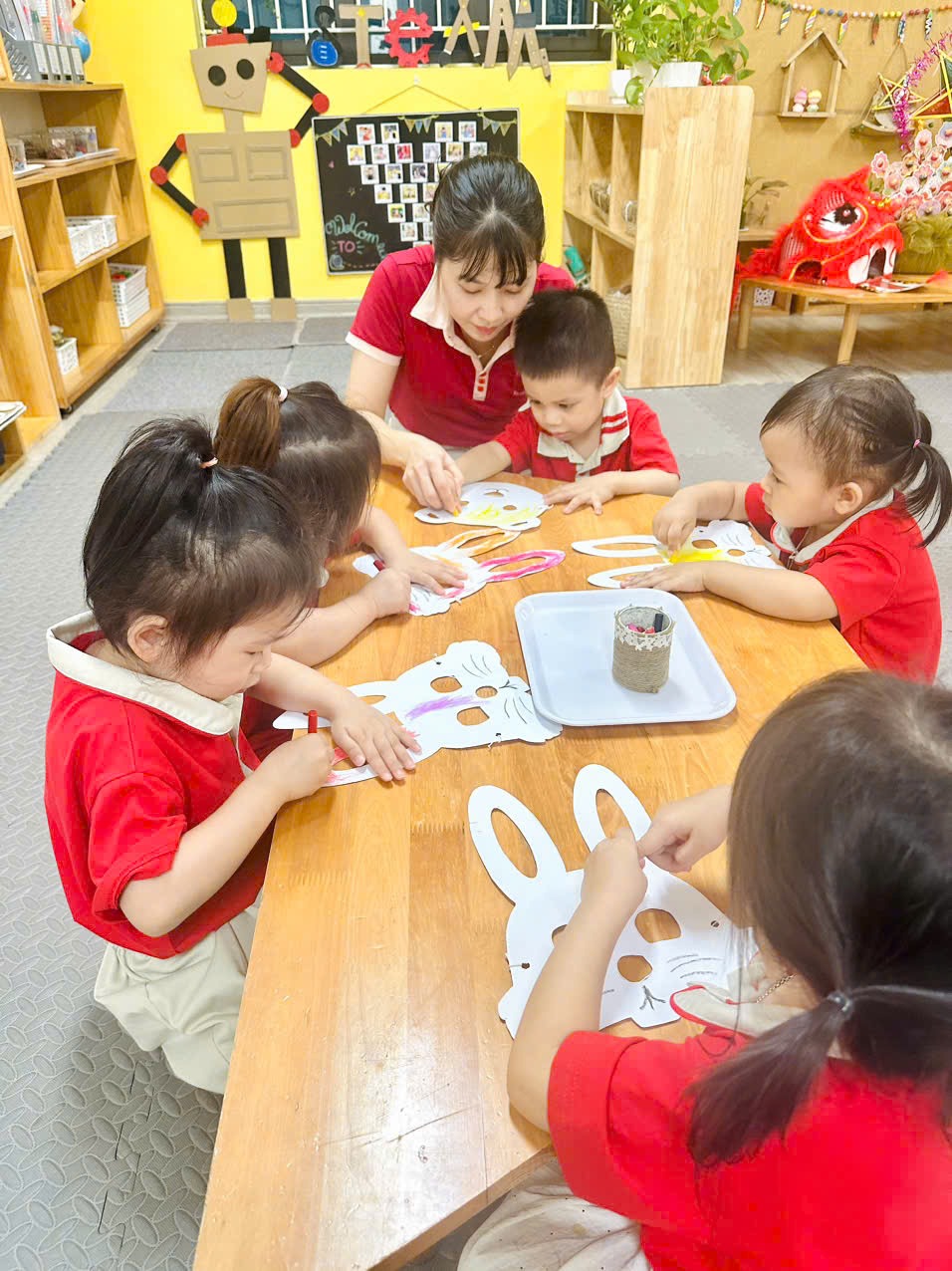 A group of children painting on paperAI-generated content may be incorrect.