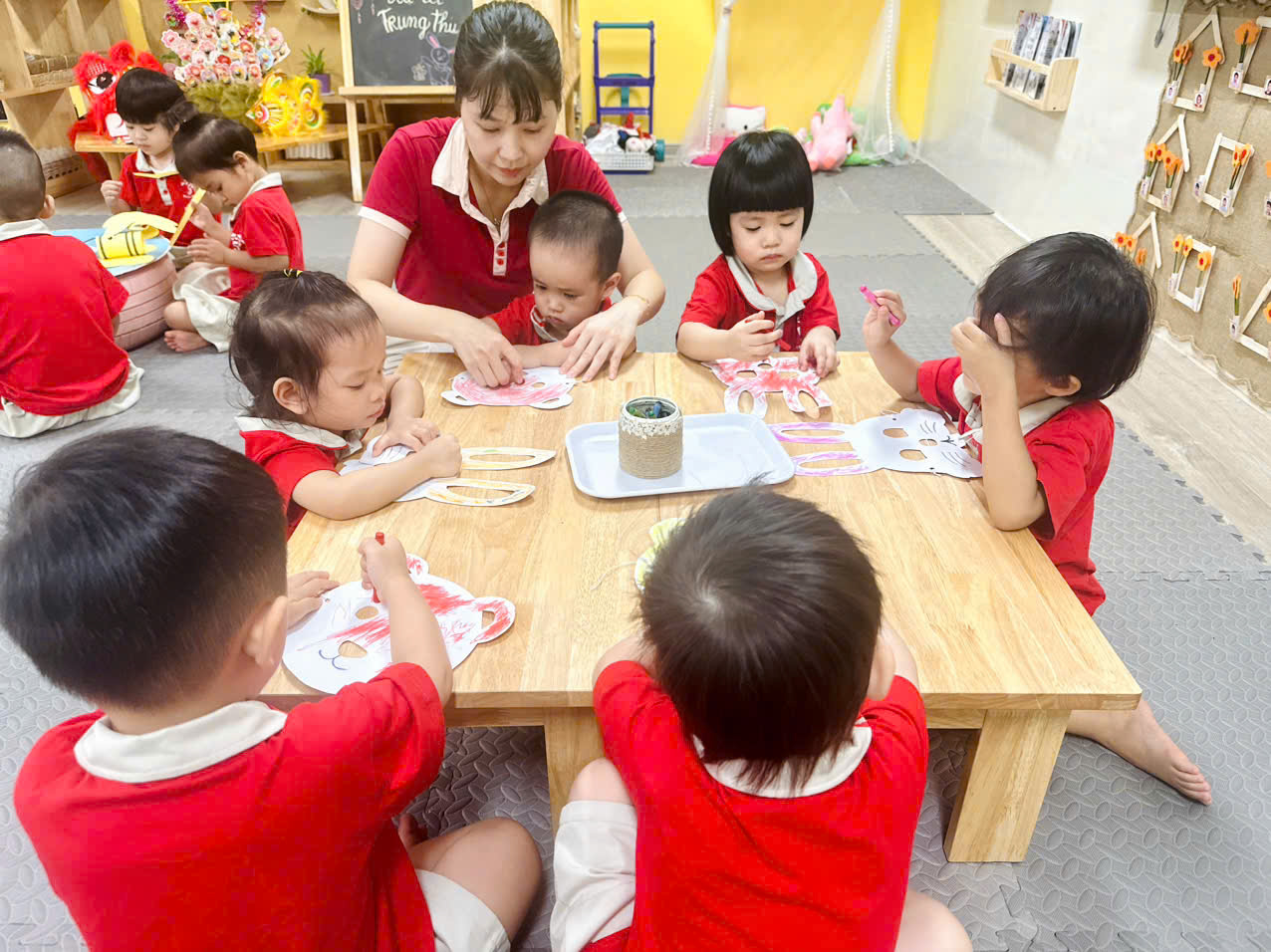A group of children sitting around a tableAI-generated content may be incorrect.