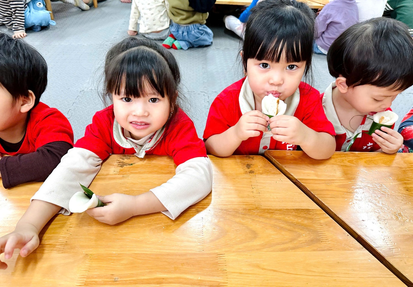 A group of children sitting at a tableAI-generated content may be incorrect.