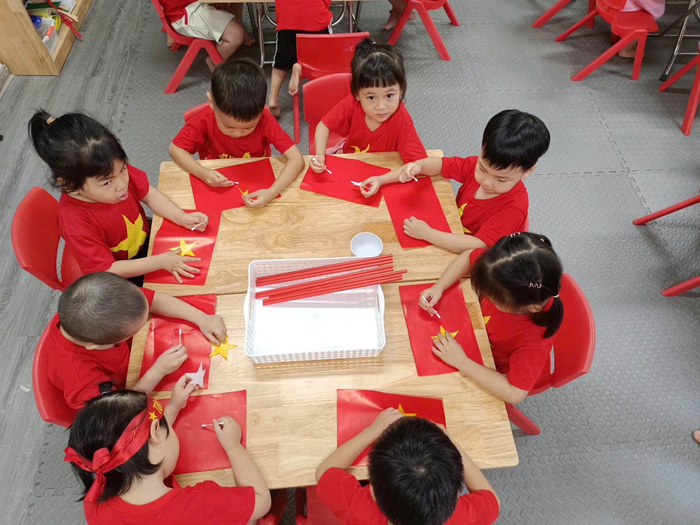 A group of children sitting at a table

AI-generated content may be incorrect.