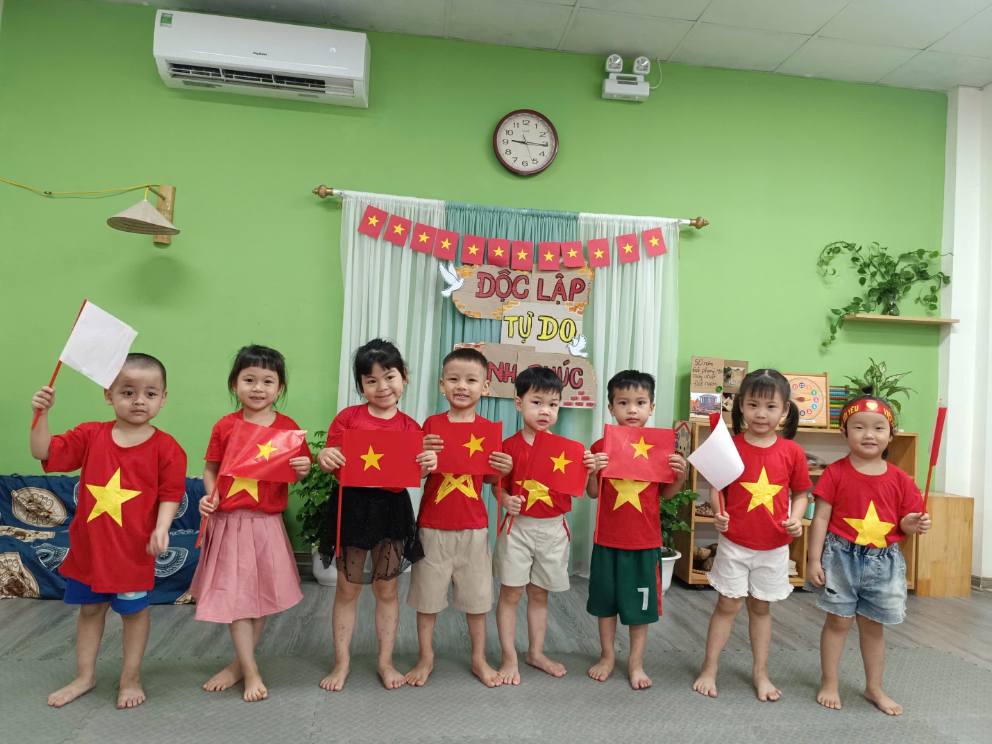 A group of children holding up red flags

AI-generated content may be incorrect.