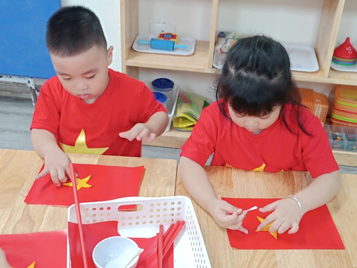 A group of children painting on red paper

AI-generated content may be incorrect.