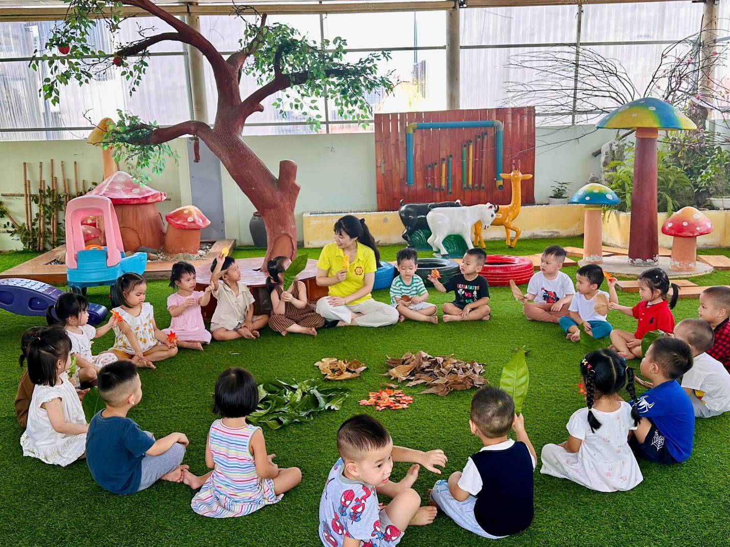 A group of children sitting on a green carpet in a circleAI-generated content may be incorrect.