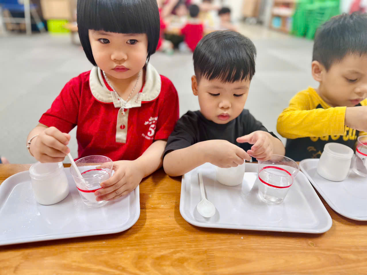 A group of children sitting at a tableAI-generated content may be incorrect.