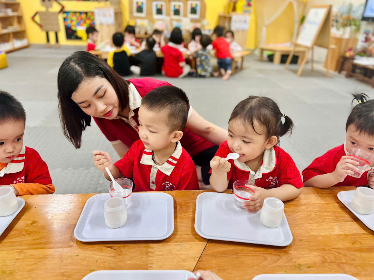 A person feeding children at a tableAI-generated content may be incorrect.