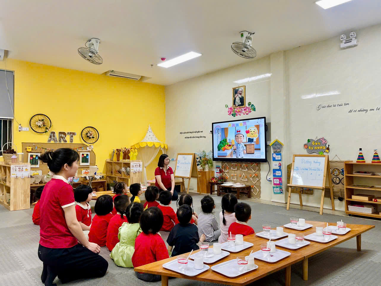 A group of children sitting on the floor in a classroomAI-generated content may be incorrect.
