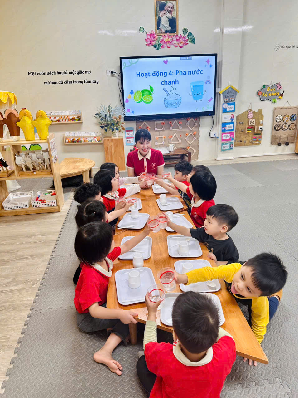 A group of children sitting around a tableAI-generated content may be incorrect.
