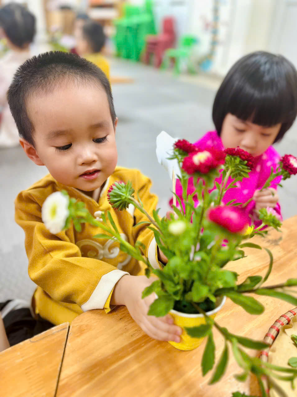 A young child and child holding flowersAI-generated content may be incorrect.