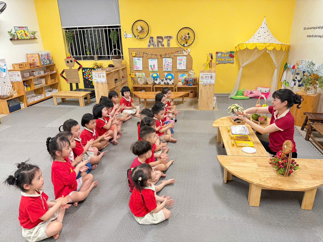 A group of children sitting on the floor in a classroomAI-generated content may be incorrect.