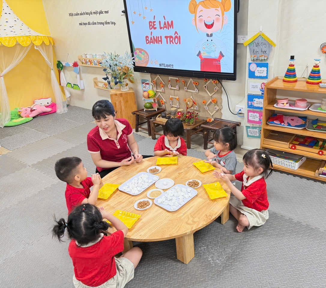 A group of children sitting around a tableAI-generated content may be incorrect.
