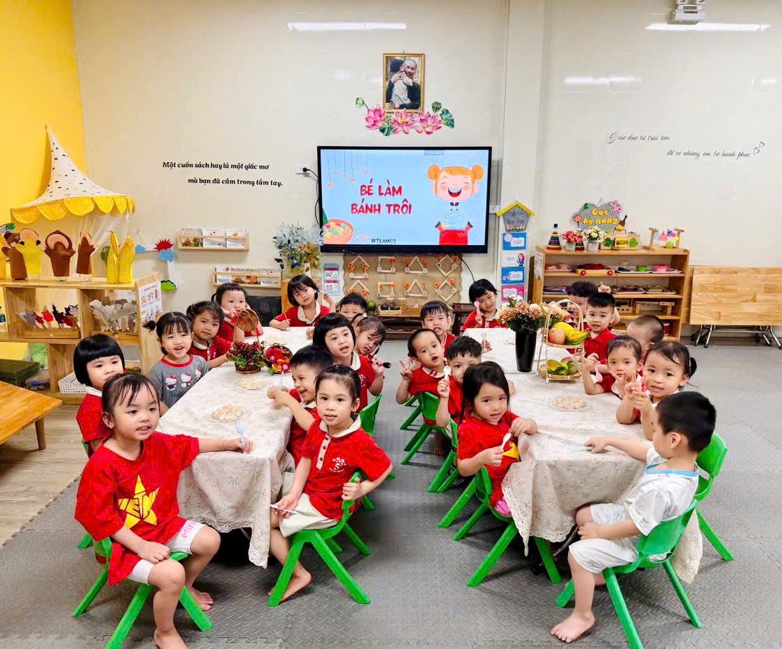 A group of children sitting at a tableAI-generated content may be incorrect.